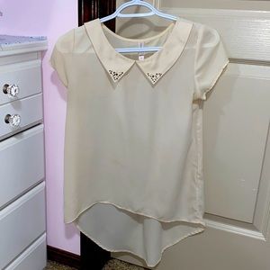 An elegant looking cream-coloured top by the brand "Xhilaration" in the XS size.